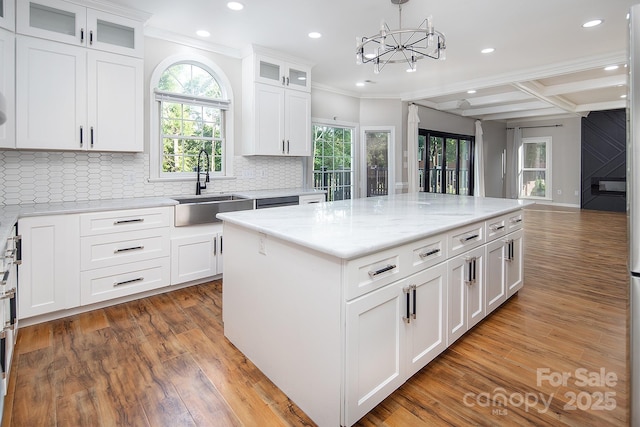 6400 Morningsong Ln, Charlotte, NC 28269 - kitchen with light wood-style flooring, recessed lighting, ornamental molding, decorative backsplash, and white cabinets