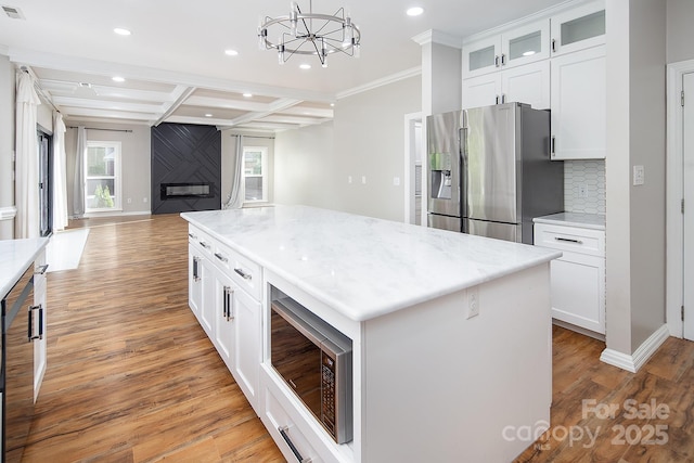 6400 Morningsong Ln, Charlotte, NC 28269 - kitchen featuring stainless steel fridge with ice dispenser, recessed lighting, built in microwave, backsplash, and open floor plan