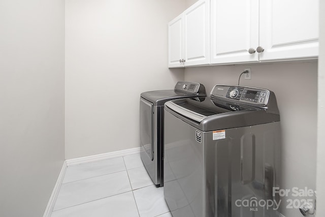 6400 Morningsong Ln, Charlotte, NC 28269 - laundry area with cabinet space, washing machine and clothes dryer, and light tile patterned floors