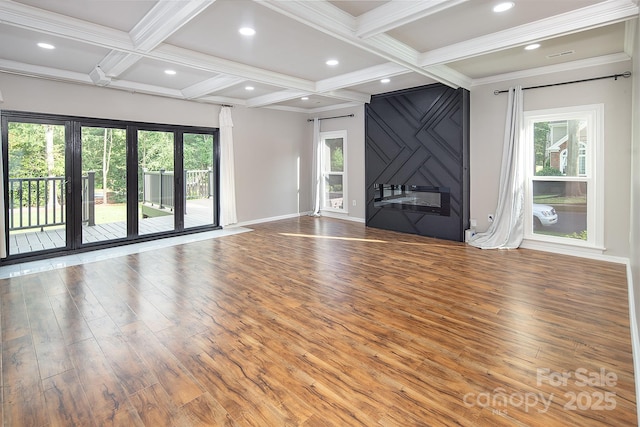 6400 Morningsong Ln, Charlotte, NC 28269 - unfurnished living room featuring wood finished floors, plenty of natural light, coffered ceiling, beamed ceiling, and crown molding