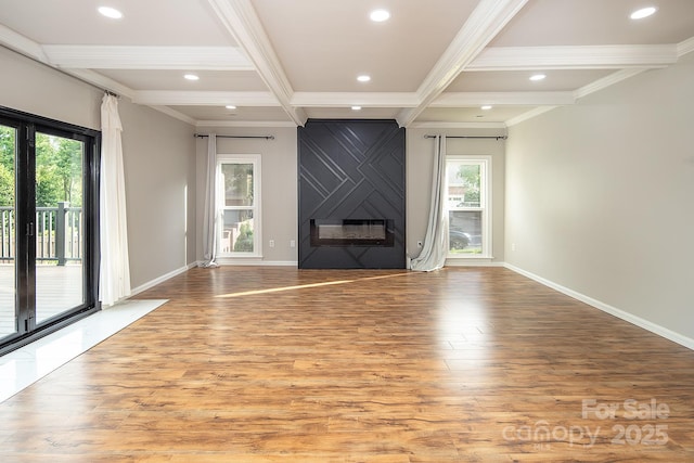 6400 Morningsong Ln, Charlotte, NC 28269 - unfurnished living room with light wood-type flooring, recessed lighting, ornamental molding, beamed ceiling, and a large fireplace