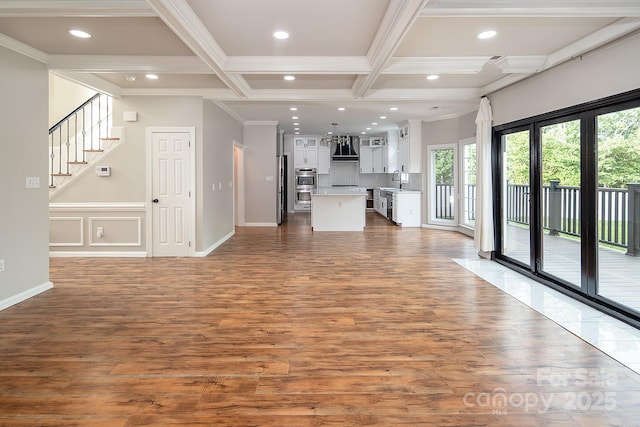 6400 Morningsong Ln, Charlotte, NC 28269 - unfurnished living room featuring wood finished floors, coffered ceiling, recessed lighting, crown molding, and beam ceiling
