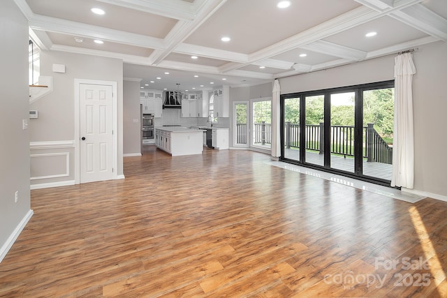 6400 Morningsong Ln, Charlotte, NC 28269 - unfurnished living room featuring coffered ceiling, light wood-type flooring, beamed ceiling, recessed lighting, and crown molding