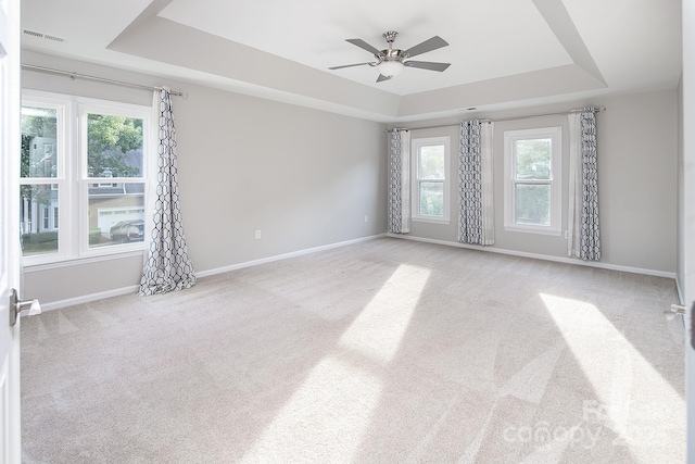 6400 Morningsong Ln, Charlotte, NC 28269 - spare room with a raised ceiling, plenty of natural light, carpet floors, and ceiling fan
