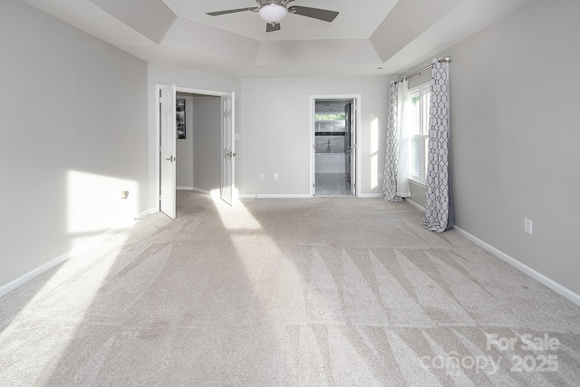 6400 Morningsong Ln, Charlotte, NC 28269 - unfurnished room with a tray ceiling, a ceiling fan, and carpet