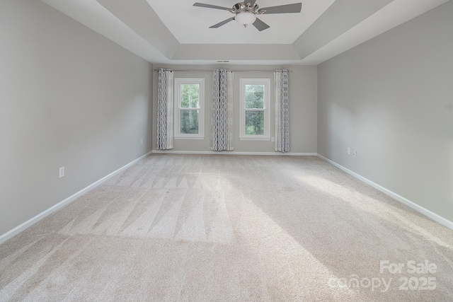 6400 Morningsong Ln, Charlotte, NC 28269 - spare room with ceiling fan, a tray ceiling, and carpet floors