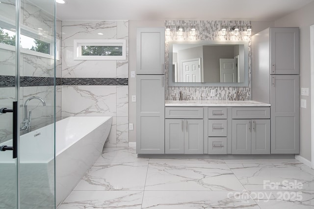 6400 Morningsong Ln, Charlotte, NC 28269 - bathroom with marble tiled flooring, a soaking tub, and double vanity
