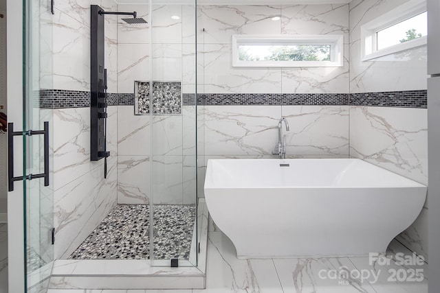 6400 Morningsong Ln, Charlotte, NC 28269 - bathroom with a soaking tub, a marble finish shower, marble finish flooring, and tile walls