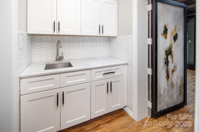 6400 Morningsong Ln, Charlotte, NC 28269 - kitchen featuring white cabinetry, light wood finished floors, and decorative backsplash