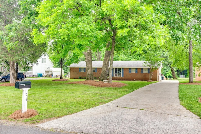 504 Amon Ln, Pineville, NC 28134 - view of front of house featuring driveway, a front lawn, and brick siding