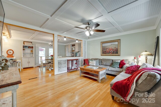 504 Amon Ln, Pineville, NC 28134 - living area featuring coffered ceiling, hardwood / wood-style floors, a chandelier, a ceiling fan, and ornamental molding