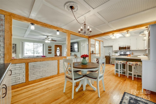 504 Amon Ln, Pineville, NC 28134 - dining space with light wood-style flooring, a ceiling fan, a chandelier, beamed ceiling, and coffered ceiling