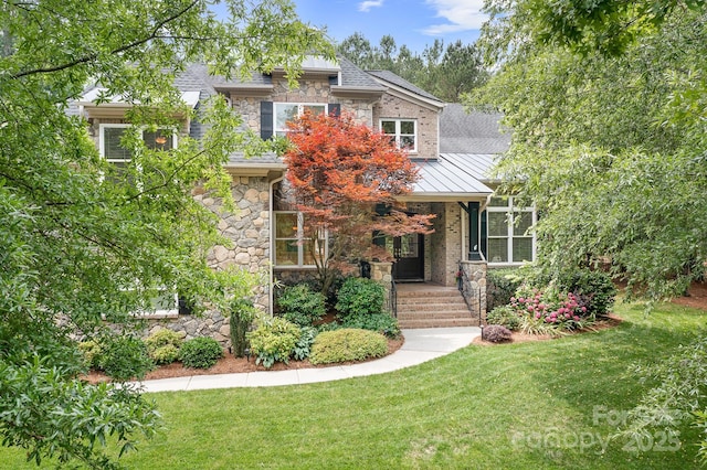 3204 Mcpherson St, Waxhaw, NC 28173 - view of front of house featuring stone siding, a standing seam roof, a front lawn, and covered porch