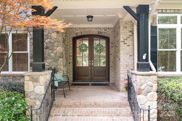 3204 Mcpherson St, Waxhaw, NC 28173 - property entrance featuring french doors, covered porch, and brick siding