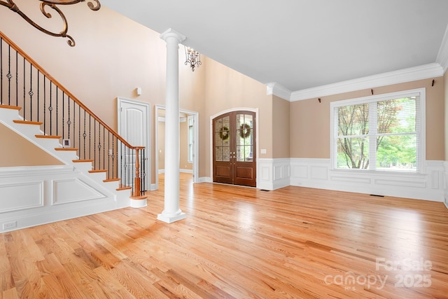3204 Mcpherson St, Waxhaw, NC 28173 - foyer entrance featuring ornate columns, wood finished floors, wainscoting, stairway, and ornamental molding