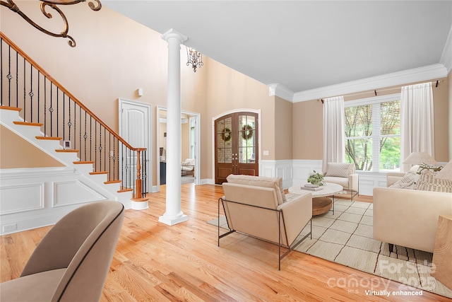 3204 Mcpherson St, Waxhaw, NC 28173 - living room with decorative columns, wood finished floors, wainscoting, stairway, and crown molding
