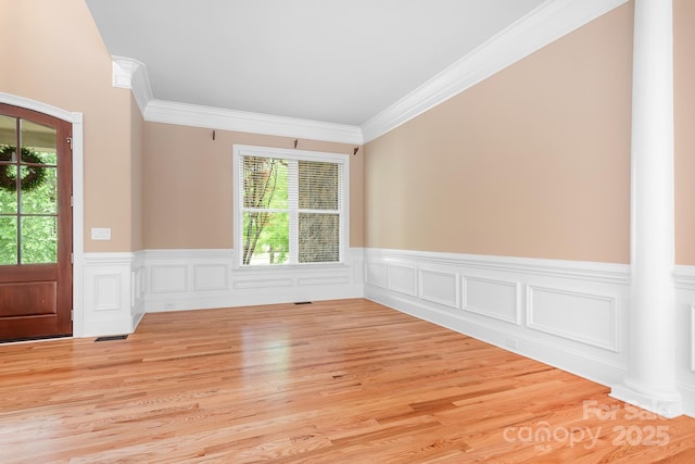 3204 Mcpherson St, Waxhaw, NC 28173 - unfurnished room with plenty of natural light, wainscoting, decorative columns, ornamental molding, and light wood-type flooring