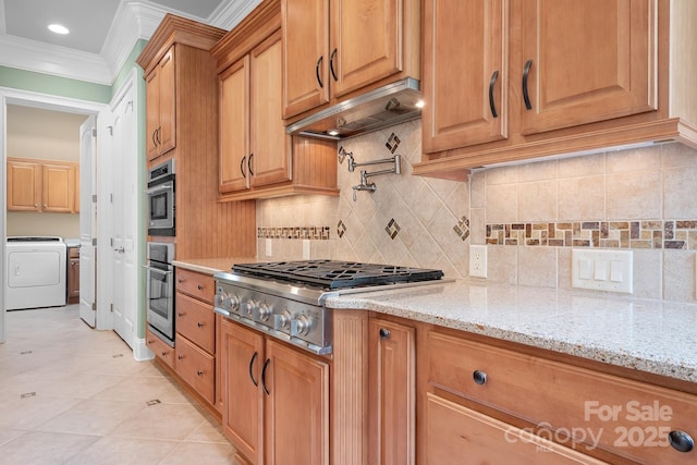 3204 Mcpherson St, Waxhaw, NC 28173 - kitchen featuring washer / clothes dryer, appliances with stainless steel finishes, crown molding, premium range hood, and light stone countertops