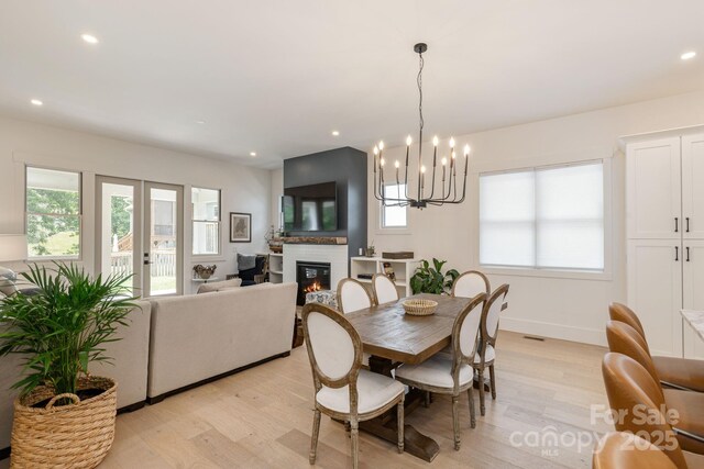 40 Hidden Pond Ln, Brevard, NC 28712 - dining space featuring light wood finished floors, a large fireplace, a chandelier, recessed lighting, and baseboards