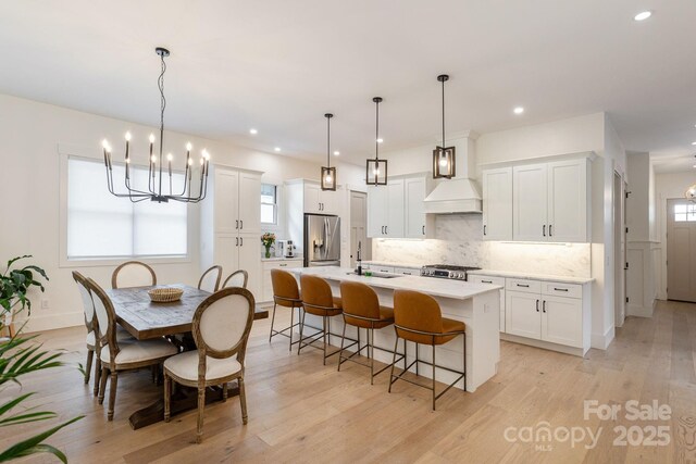 40 Hidden Pond Ln, Brevard, NC 28712 - kitchen with stainless steel fridge, a chandelier, range, a sink, and recessed lighting