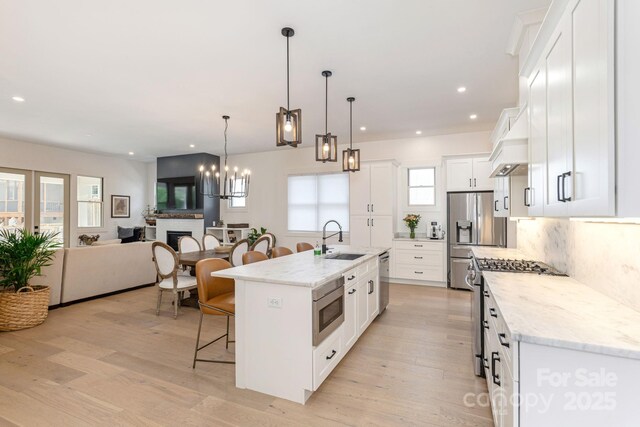 40 Hidden Pond Ln, Brevard, NC 28712 - kitchen with a sink, a breakfast bar area, open floor plan, stainless steel appliances, and an island with sink