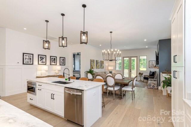 40 Hidden Pond Ln, Brevard, NC 28712 - kitchen with stainless steel appliances, a sink, open floor plan, light wood-style floors, and recessed lighting