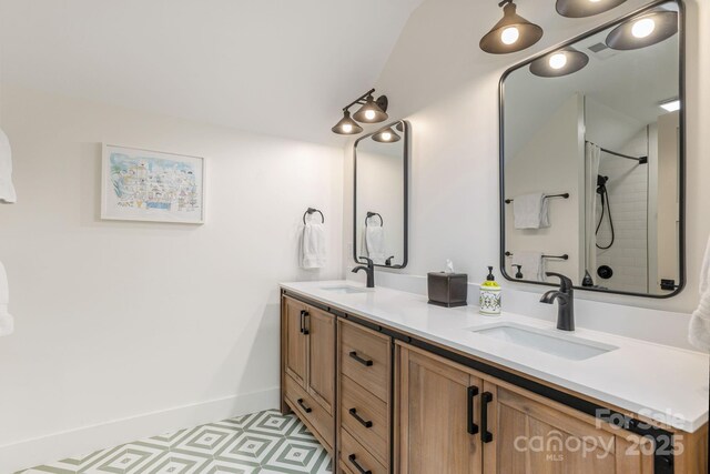 40 Hidden Pond Ln, Brevard, NC 28712 - bathroom featuring double vanity, baseboards, and a shower