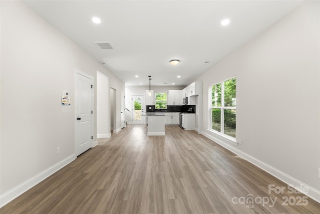 105 Spring Garden Dr, Gastonia, NC 28052 - unfurnished living room featuring recessed lighting, baseboards, and light wood-style flooring