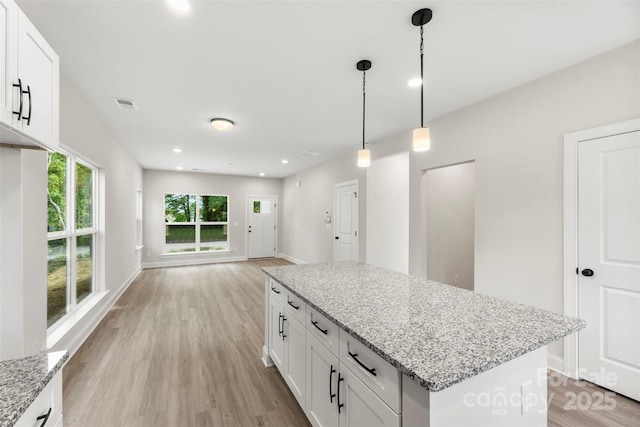 105 Spring Garden Dr, Gastonia, NC 28052 - kitchen with light wood-type flooring, white cabinets, light stone counters, and recessed lighting