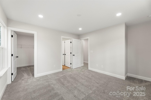 105 Spring Garden Dr, Gastonia, NC 28052 - unfurnished bedroom with carpet flooring, a spacious closet, baseboards, recessed lighting, and a closet