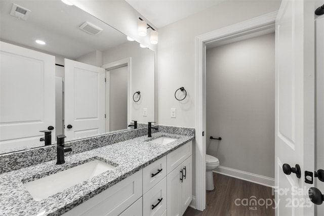 105 Spring Garden Dr, Gastonia, NC 28052 - full bath featuring toilet, double vanity, wood finished floors, and baseboards
