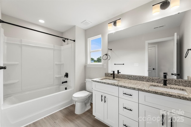 105 Spring Garden Dr, Gastonia, NC 28052 - bathroom featuring wood finished floors, toilet, double vanity, and bathtub / shower combination