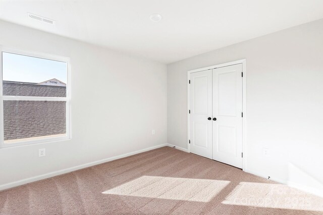 3323 Burberry Dr, Gastonia, NC 28052 - unfurnished bedroom with light colored carpet, baseboards, and a closet