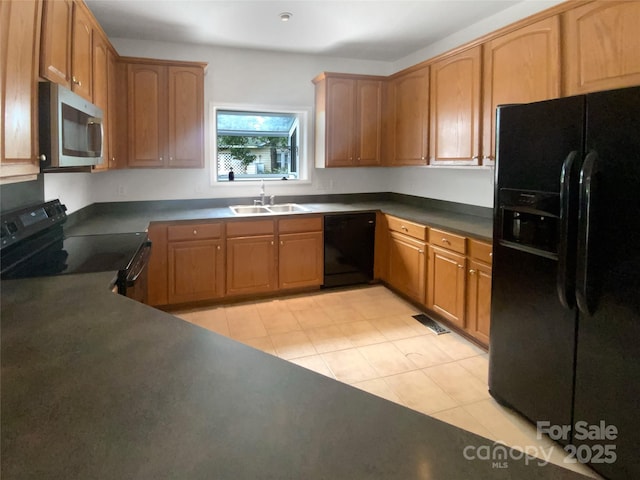 204 W Boyd St, Maiden, NC 28650 - kitchen featuring black appliances, a sink, dark countertops, light tile patterned floors, and brown cabinets
