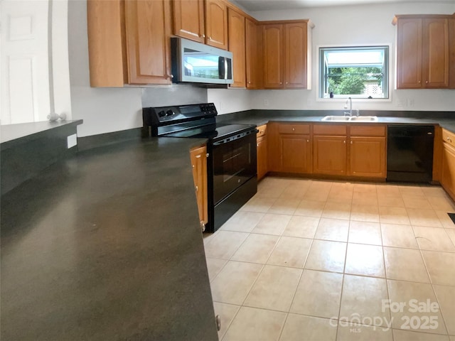 204 W Boyd St, Maiden, NC 28650 - kitchen with black appliances, a sink, dark countertops, brown cabinets, and light tile patterned floors