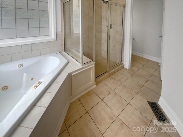 204 W Boyd St, Maiden, NC 28650 - bathroom featuring tile patterned flooring, a shower stall, a whirlpool tub, and baseboards