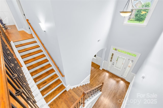 2289 Pine Valley Dr, Denver, NC 28037 - entrance foyer featuring wood finished floors, arched walkways, stairs, a high ceiling, and baseboards