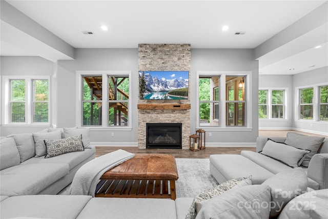 2289 Pine Valley Dr, Denver, NC 28037 - living area featuring wood finished floors, baseboards, a stone fireplace, and recessed lighting
