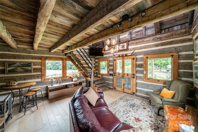 2310 Gill Jordan Rd, Chester, SC 29706 - living room featuring wooden walls, a wood ceiling with exposed beams, french doors, light wood-style flooring, and stairway