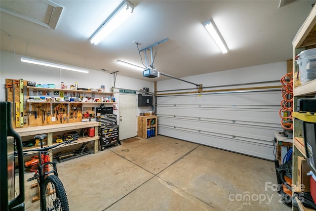 2310 Gill Jordan Rd, Chester, SC 29706 - garage with a workshop area and a garage door opener