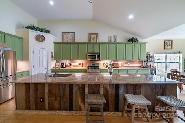 2310 Gill Jordan Rd, Chester, SC 29706 - kitchen featuring green cabinets, stainless steel appliances, high vaulted ceiling, a kitchen bar, and light wood finished floors