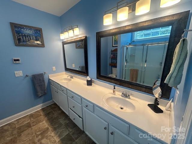 2310 Gill Jordan Rd, Chester, SC 29706 - bathroom featuring double vanity, a stall shower, and stone finish floors