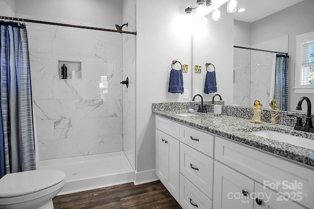 5016 Old Pine Ln, Cherryville, NC 28021 - bathroom with double vanity, toilet, a tile shower, and wood finished floors
