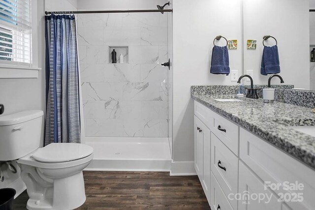 5016 Old Pine Ln, Cherryville, NC 28021 - full bathroom featuring toilet, double vanity, wood finished floors, and a stall shower