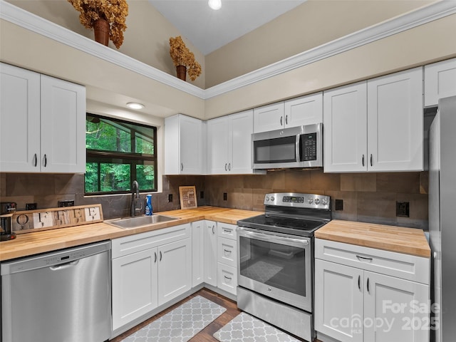 100 Tarragon Pl, Flat Rock, NC 28731 - kitchen featuring wooden counters, stainless steel appliances, a sink, white cabinetry, and high vaulted ceiling