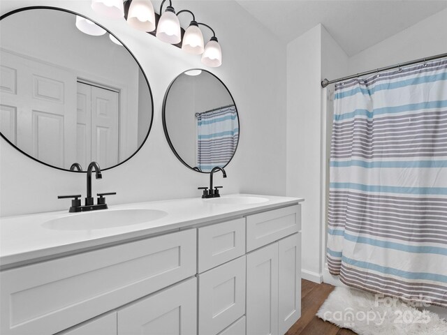 100 Tarragon Pl, Flat Rock, NC 28731 - bathroom with double vanity, wood finished floors, and curtained shower
