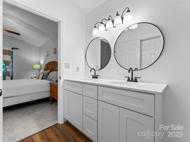 100 Tarragon Pl, Flat Rock, NC 28731 - ensuite bathroom with vaulted ceiling, wood finished floors, double vanity, and ceiling fan