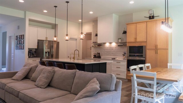 4710 Old Pageland Marshville Rd, Monroe, NC 28112 - kitchen featuring open floor plan, appliances with stainless steel finishes, backsplash, light countertops, and light brown cabinetry