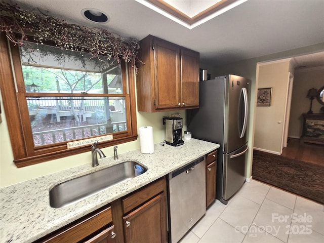 105 Bent Creek Blvd Unit 16, Lake Lure, NC 28746 - kitchen featuring stainless steel appliances, a sink, light tile patterned floors, and light stone countertops