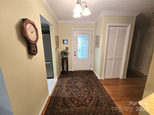 105 Bent Creek Blvd Unit 16, Lake Lure, NC 28746 - entryway with a chandelier, ornamental molding, wood finished floors, and baseboards